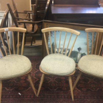 A set of four blonde Ercol dinning chairs stick back with original seat covers (4)