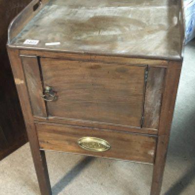 A George III mahogany cabinet with a raised three quarter gallery above a single drawer and cupboard