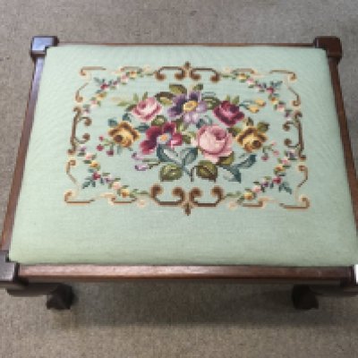 An Edwardian stool decorated with flower embroidery.