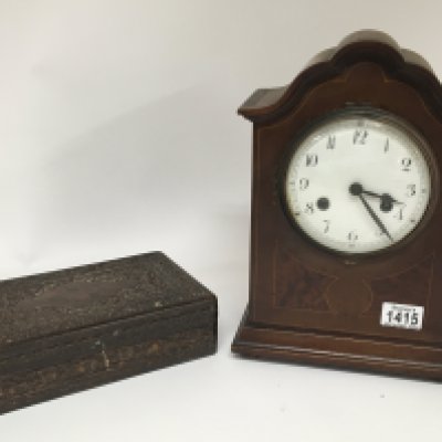 An Early 20th century walnut clock with an enamel dial. and a profusely carved and inlaid box (2)