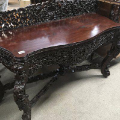 A Anglo Indian side table the raised carved back above cabriole legs United By stretchers .