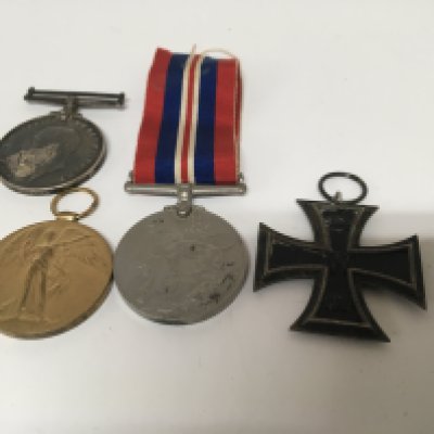 A German Imperial iron Cross 1813/1914. Two First World War medals awarded to 427 Pte G Barker midd x R also one other awarded to SS.100105 HW Mills STO 1 RN and a Second World War medal.