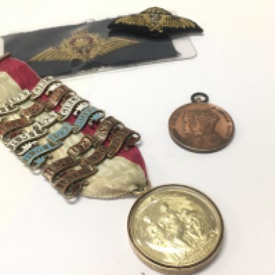 A Masonic medal with a 15ct gold border, society of miniature rifles club medal the kings silver jubilee and RAF badges. Postage category A