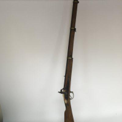 An Antique percussion rifle with three brass barrel and rings muzzle load with ram rod.