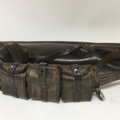 A Military leather belt magazine holster with several compartments and a leather gun case and one other leather magazine case (3)