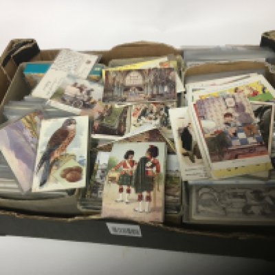 A box containing a good selection of Postcards Including vintage commercial cards Celesque cards Tuck and lots of George V stamped used postcards landscapes monuments some in plastic sleeves.