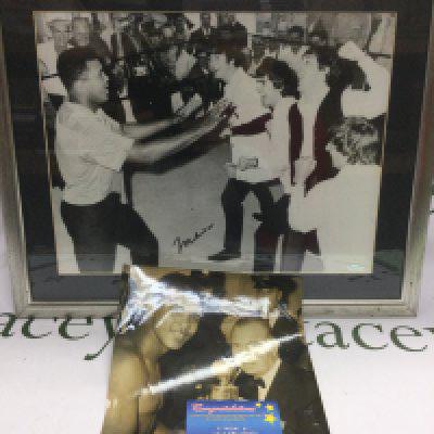 A framed and glazed signed print of Muhammad Ali with The Beatles, signed by Ali only. Comes with a further unsigned print of Ali and a COA. Shipping category D.