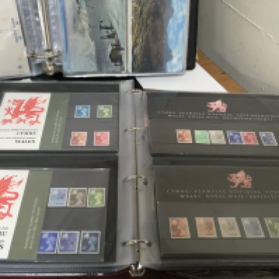 An album containing Welsh and Northern Irish Elizabeth II presentation packs an album of Vintage Air mail covers an album containing postcards of Commercial Aircraft and three other albums of postcards.