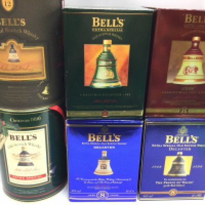 A collection of 6 bottles of commemorative editions of bells Whisky.