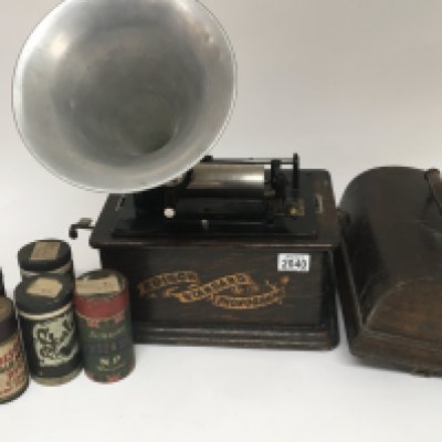 An Edison Standard Phonograph with a large quantity of music rolls some in boxes with an aluminium horn.