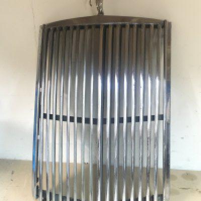 An unusual vintage chrome car grill with small chrome mascot holding victory wreath possibly from a sports car, 52cm tall. this lot cannot be posted