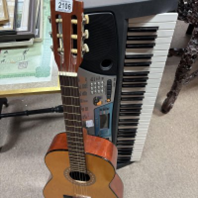 A Yamaha PSR 17 Keyboard and a Spanish guitar. Shipping Category D NO RESERVE