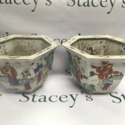 A pair of Chinese export jardinieres of hexagonal form with hand painted decoration of figures in a garden setting, approx height 20cm. Shipping category D.
