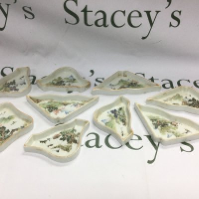 A set of nine Oriental sweet meat dishes decorated with various Oriental landscape scenes.