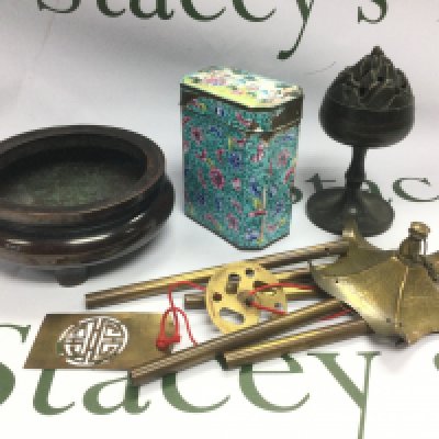 A small box of items comprising a heavy bronzed bowl, enamel container, wind chimes etc. Shipping category D.