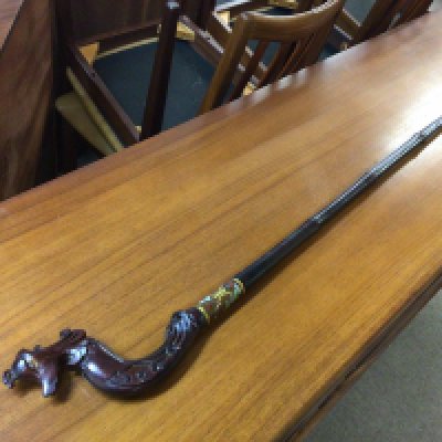 A Chinese wooden walking stick with a phoenix head shaped handle and a cloisonne collar. No reserve