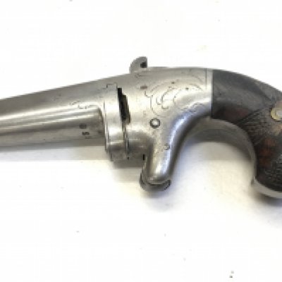 A .41 CALIBRE NATIONAL ARMS CO. SINGLE SHOT DERINGER, NO.8538 CIRCA 1865-70; of standard production specifications, the barrel stamped National Arms Co. Brooklyn NY~, engraved frame, knurled trigger and chequered walnut grip action functional.