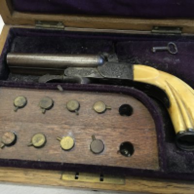 A Nice Example of a 19th Century Continental pin fire double barrel pistol with engraved action retractable triggers under leaver sliding opener for loading barrels in a fitted case with pin fire cartridges action working.
