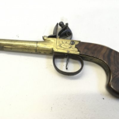An Antique flint lock pistol with brass barrel and action walnut grip missing flick bayonet fitting. The action stamped Bafs London.