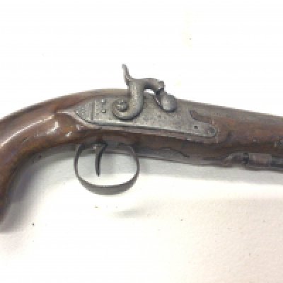An Antique early 19th century percussion pistol with walnut stock full length steel action stamped with makers mark London on the barrel.