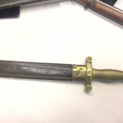 A French 1831 pattern Gladiator type short sword brass grip and steel blade in a leather scabbard with makers marks to the blade also numbered on the hilt 323.