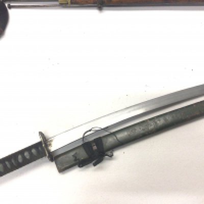 A replica Japanese II world war issue Wakizashi sword with green grip and metal green scabbard.