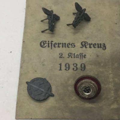 A collection of German Third Reich party badges and others with a 1939 envelope.