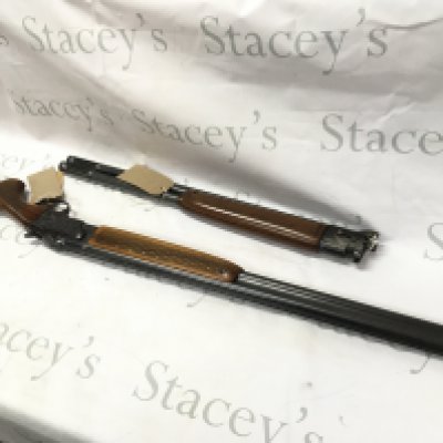 A 12 gauge over and under shotgun with walnut stock. Double trigger with ejector and fixed choke. Comes with spare barrel. BRNO model ZH303. Serial number 317773. PLEASE NOTE THAT A SHOTGUN LICENSE IS REQUIRED TO PURCHASE THIS ITEM. COLLECTION AND VIEWING BY APPOINTMENT ONLY.