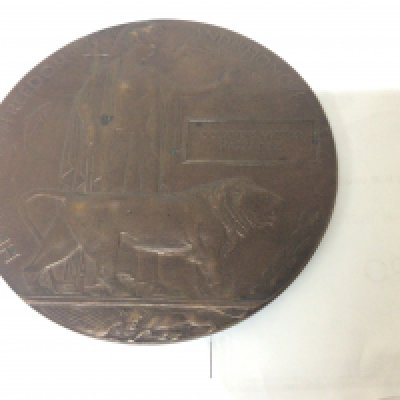 A Bronze memorial plaque awarded to Octavians Victor Harradine 33510 5th Bt Border Regiment killed on the 10th August 1918.