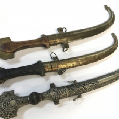 Three Moroccan Trina Koummya Daggers with brass and silvered scabbards (3)