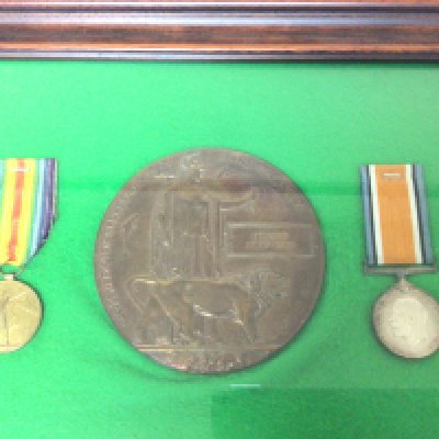 A Framed I World war Medal group and Memorial plaque awarded to Edward John Kain. The frame sealed.