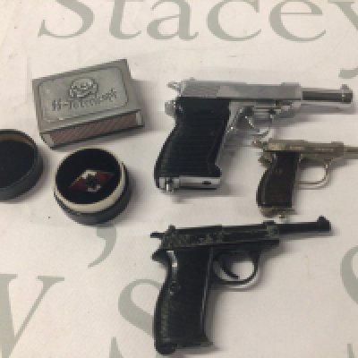 A German Third Reich match box holder an enamel Political badge late 1930s and three miniature model P38 pistols.