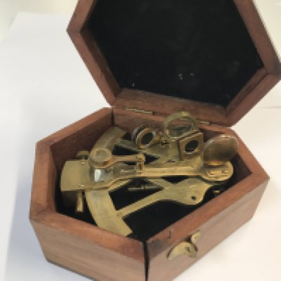 A reproduction navy brass sextant in a fitted box.