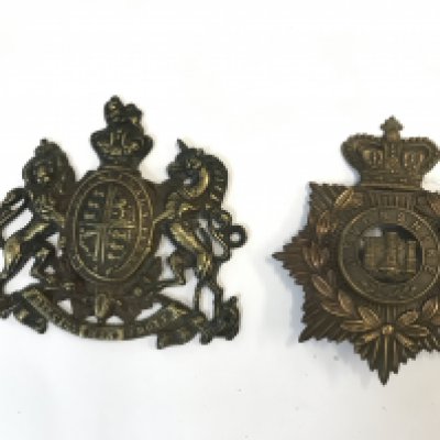 Devonshire helmet plate and a brass coat of arms plate . Postage category B