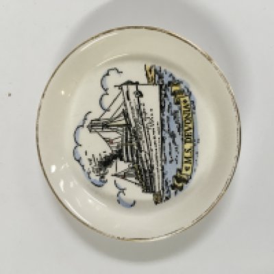 Collection of British India Steam Navigation Company items consisting of a Chrome ashtray from the B.I.S.N.Co vessel SS Nevasa, British India line souvenir ships plate showing the vessel SS Uganda, silver plated napkin ring from the British India steam navigation company, very old framed picture of the B.I.S.N.Co vessel, rare souvenir picture dish from the British India steam navigation company vessel the Me Devonia and a souvenir spoon from the British India steam company vessel the MV Dunera