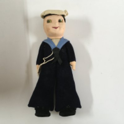 A collection of miscellaneous great liners items consisting of an as used on board ashtray from SS Cavina from the elders and fyffes line, Wedgewood souvenir from the vessel the royal yacht Britannia, posted envelope from the RMS Polaris dated 1908, sailor doll souvenir from the vessel the SS Ithaca, silver coloured napkin ring from the Nelson line vessel the SS Highland Glen and silver plated dining table salt & pepper pot from the Aberdeen & commonwealth line vessel the Diogenes