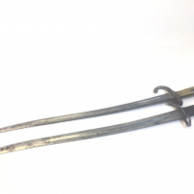 A French 1874 pattern bayonet with brass grip and one other bayonet without scabbed with unusual mark to the steel blade. (2)