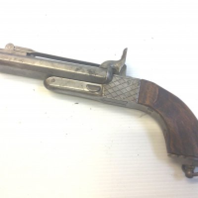 A 19th century rim fire double barrel pistol with top bayonet retractable trigger.