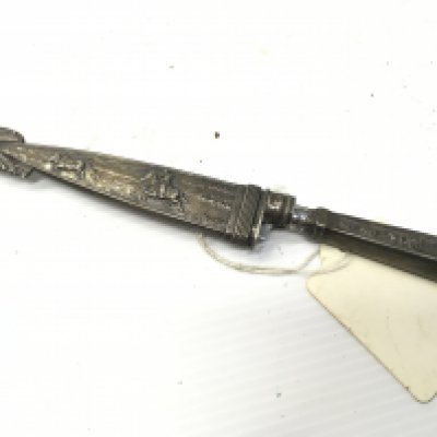 A Small white metal Gaucho knife decorated with cow boy theme stamped Inox