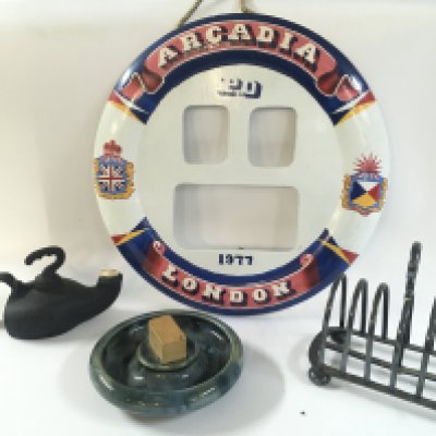 A collection of rare maritime artefacts including a silver plated toast rack from the ship the star of Victoria , hand crafted and painted wooden lifebelt model from the Arcadia, very early and excellent condition lounge ashtray from the P&O line , single torch lamp from the British India steam navigation
