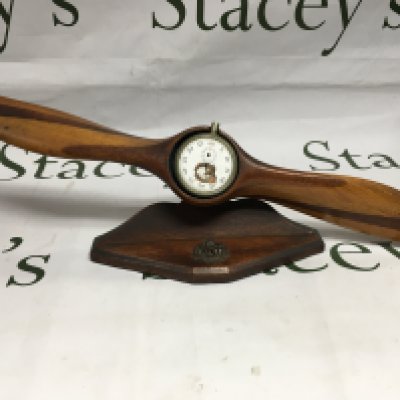 A WWI era auxiliary propeller (possible German) on a fitted stand and damaged pocket watch with RFC badge applied to stand.