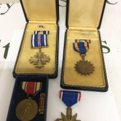 A Group of II world war American medals including Distinguished Flying Cross in a fitted box Air Medal in a fitted box Campaign service medal in original box and one other.