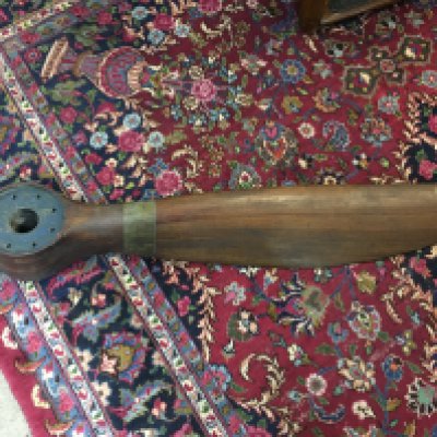 A WWI era propeller box and single blade from probable crash damage as well as various markings. Approx length 156cm.
