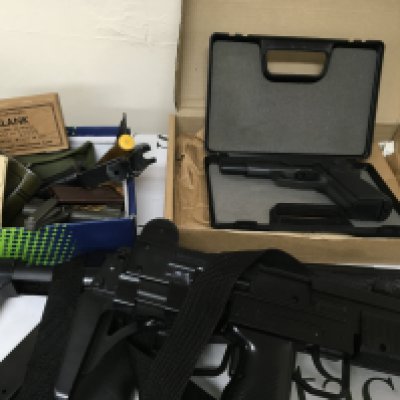 A box containing American empty vintage Cartridges and other oddments cases a blank firing Browning GP DA8 in a fitted case two plastic non firing replica machine guns.