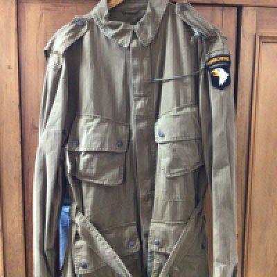 An American Military issue possible II world war field jacket and trousers. With later Airborne badge attached