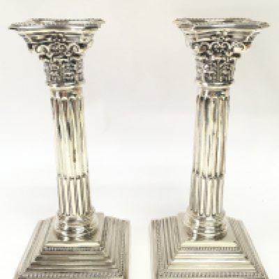 A pair of hallmarked silver Corinthian column candlesticks. 20cm tall. Postage category B