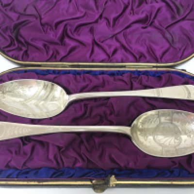 A cased pair of Exeter hallmarked silver spoons. Postage category B