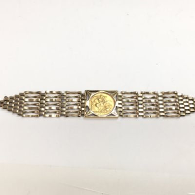 A 9 carat gold bracelet inset with a 1958 full sovereign, total weight 23.5g. Postage category A