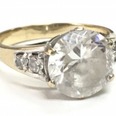 A 9 carat gold ring set with a cubic zirconia stone, size P. Total weight 3.94g. Postage category A