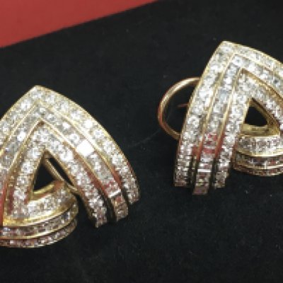 A pair of 14ct gold and diamond set earrings, postage cat A